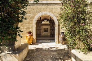 Un arco de entrada que da a una habitación con suelo estampado y vistas de otra habitación con suelo estampado.