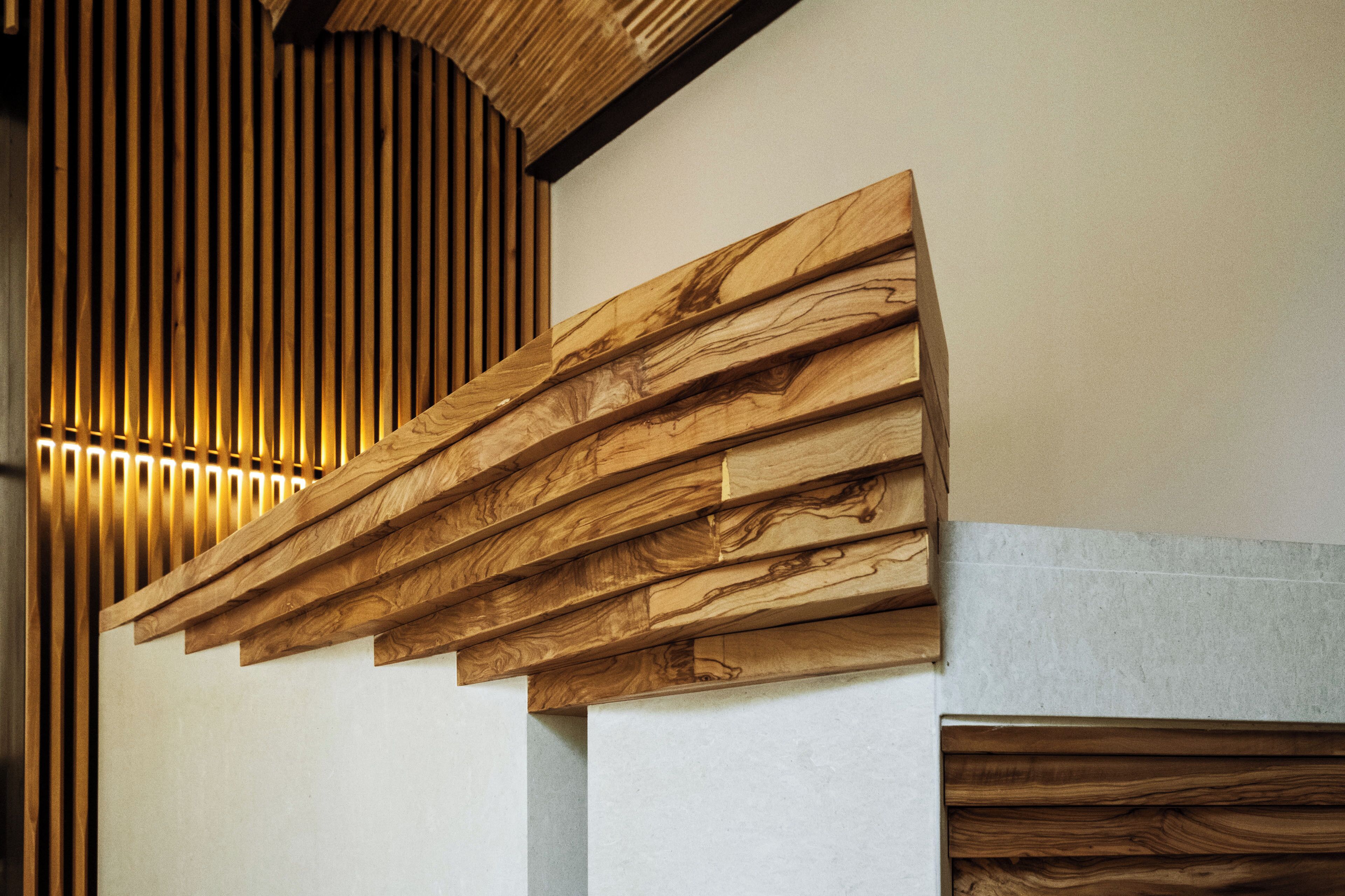A modern interior with wooden paneling and a slatted ceiling design.
