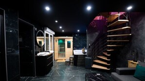 A modern interior with a marble floor, a circular mirror, a staircase, and a sofa. - Salle D'amour L'elixird'amour (Étampes-sur-Marne)