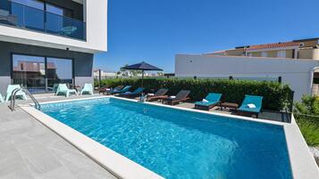 Seasonal outdoor pool, open 9:00 AM to 9:00 PM, pool umbrellas