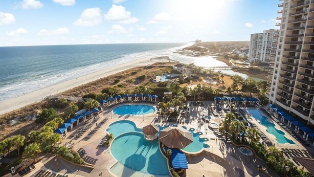 A resort with multiple swimming pools, a beach, and a high-rise building. - Coastal Comfort: 2BR Condo w/ Kitchen and Balcony (North Myrtle Beach)