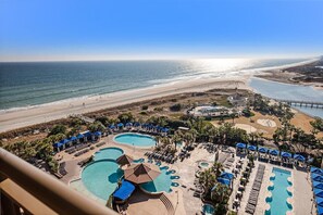 A resort with multiple swimming pools, beach access, and a view of the ocean.