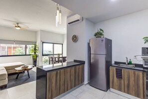 Enjoy a home away from home with a sleek kitchen, dining area, and comfortable living space.