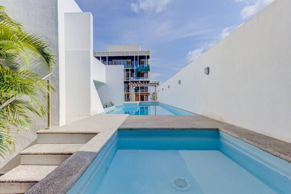 Relax by the pool surrounded by lush greenery and take in the views from the hotel's contemporary balconies.