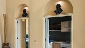 A modern kitchen with an open layout, wooden cabinets, and a built-in oven.