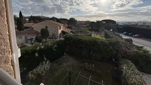 A residential area with houses, a road, and a clear sky with clouds.