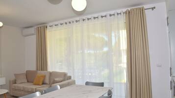 Family Apartment, Multiple Bedrooms (White Moon Apartment 302) | Living area | 21-inch flat-screen TV with cable channels