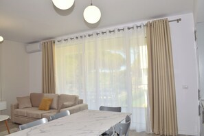 Family Apartment, 2 Bedrooms (White Moon Apartment 302) | Living area | 21-inch flat-screen TV with cable channels