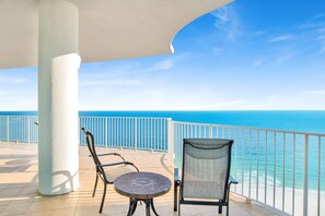 A balcony with a view of the ocean, two chairs, and a table. - Escape to one of the Gulf Coast's premier destinations. Turquoise Place in Orange Beach, Alabama (Orange Beach)