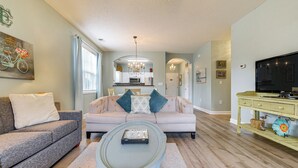 A living room with a sofa, coffee table, and television.
