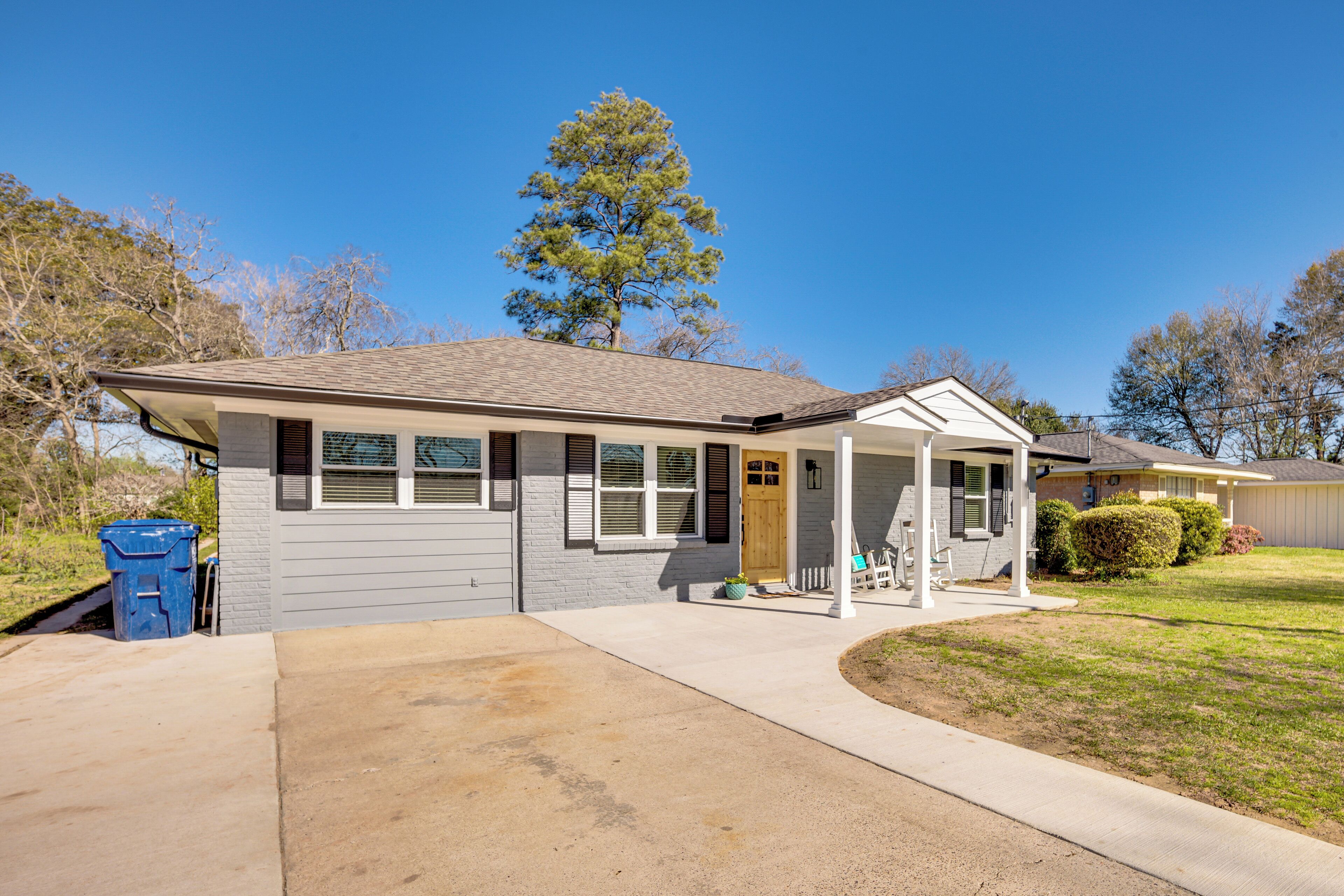 A single-story house with a front porch, a garage, and a well-maintained lawn.