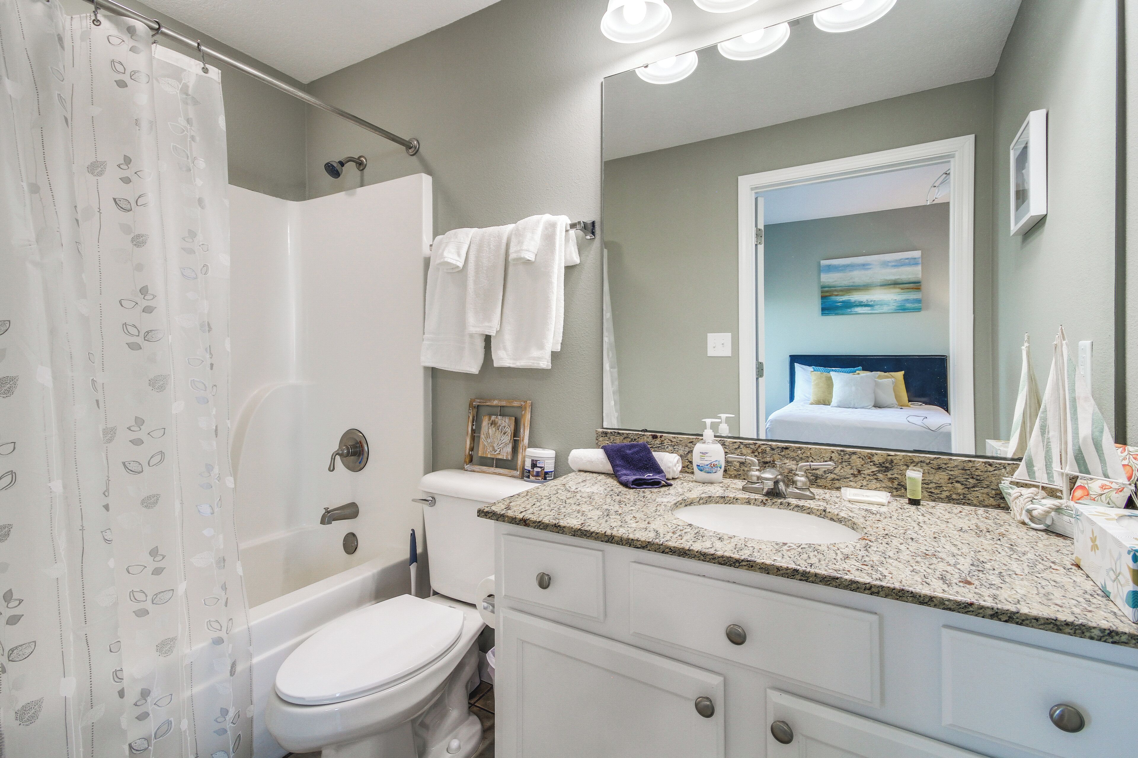 A bathroom with a bathtub, toilet, and sink.