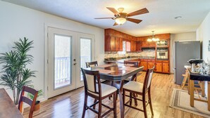 A spacious kitchen with wooden cabinets, a central island, and a ceiling fan. - Peaceful Trenton Home w/ Patio Near Hiking! (Trenton)