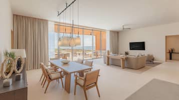 A modern living room with a dining area, large windows, and a flat-screen TV.
