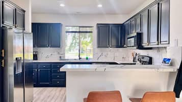 Coffee/tea maker, fridge, microwave, oven