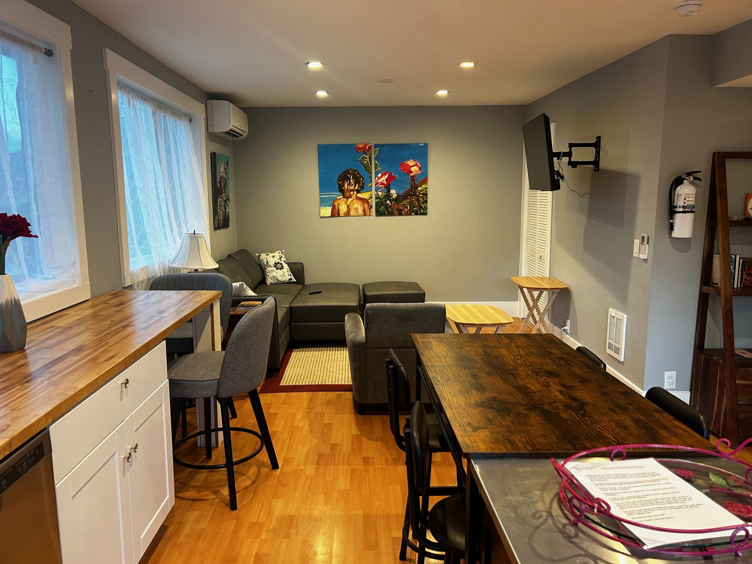 A compact living space with a kitchenette, dining area, and seating.