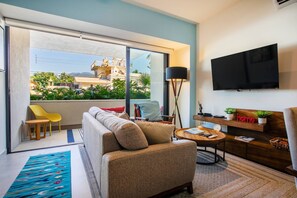 Cozy living room with smart TV and access to the private balcony - Rooftop Views + Gym + Parking | 2BR in Versalles (Puerto Vallarta)