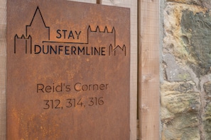 A sign with the text "DUNFERMLINE" and "Reid's Corner" along with phone numbers. - 312 Reid's Corner - by Stay Dunfermline (Dunfermline)