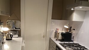 Una cocina compacta con estufa a gas, tostadora y pileta.