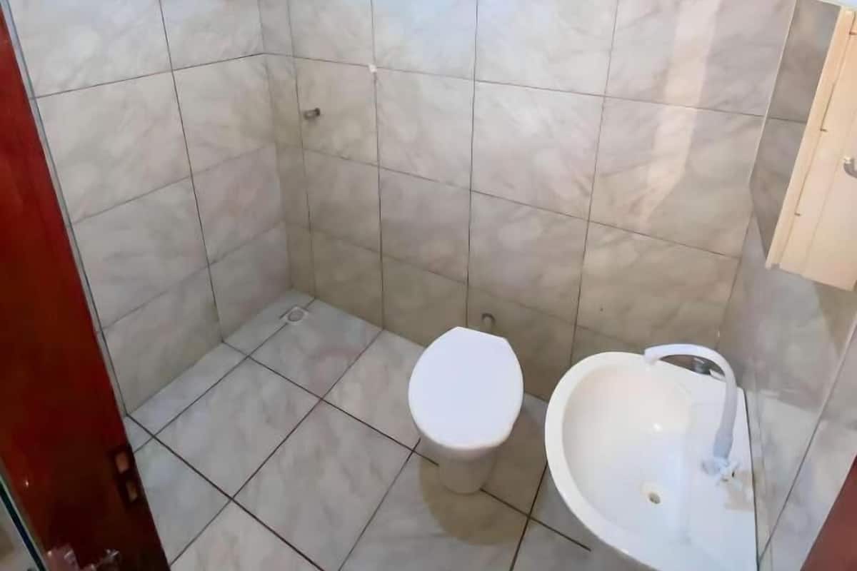 A bathroom with a shower, toilet, and sink.