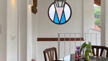 Enjoy meals in this stylish dining area with a glass-top table and comfortable seating.