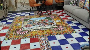 A cozy living room with a stone wall, a sofa, a coffee table, and a vibrant patterned rug. - macchiamediterrane (Castellammare del Golfo)