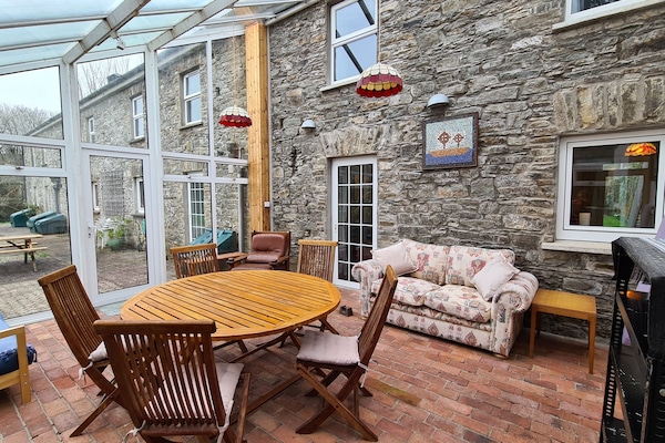 Conservatory - Additional dining and seating area in warm weather.