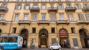 A historic building with multiple balconies, a central entrance with a door, and a sign for 'Sant'Angelo'. - Torino Station Relais (Turin)