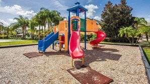 A playground with slides and a climbing structure. - 4BR Townhome 6 mile to Disney (Kissimmee)