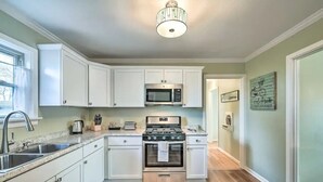 A kitchen with white cabinets, a stainless steel sink, a microwave, a stove, and a toaster. - Walk to FIFA World Cup! 1mi to AT&T Stadium - Texas Live! - GlobeLife Field. (Arlington)
