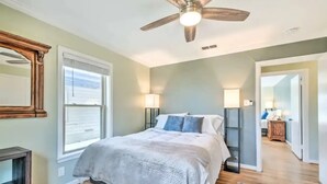 A bedroom with a bed, a ceiling fan, a nightstand, and a lamp. - Walk to FIFA World Cup! 1mi to AT&T Stadium - Texas Live! - GlobeLife Field. (Arlington)