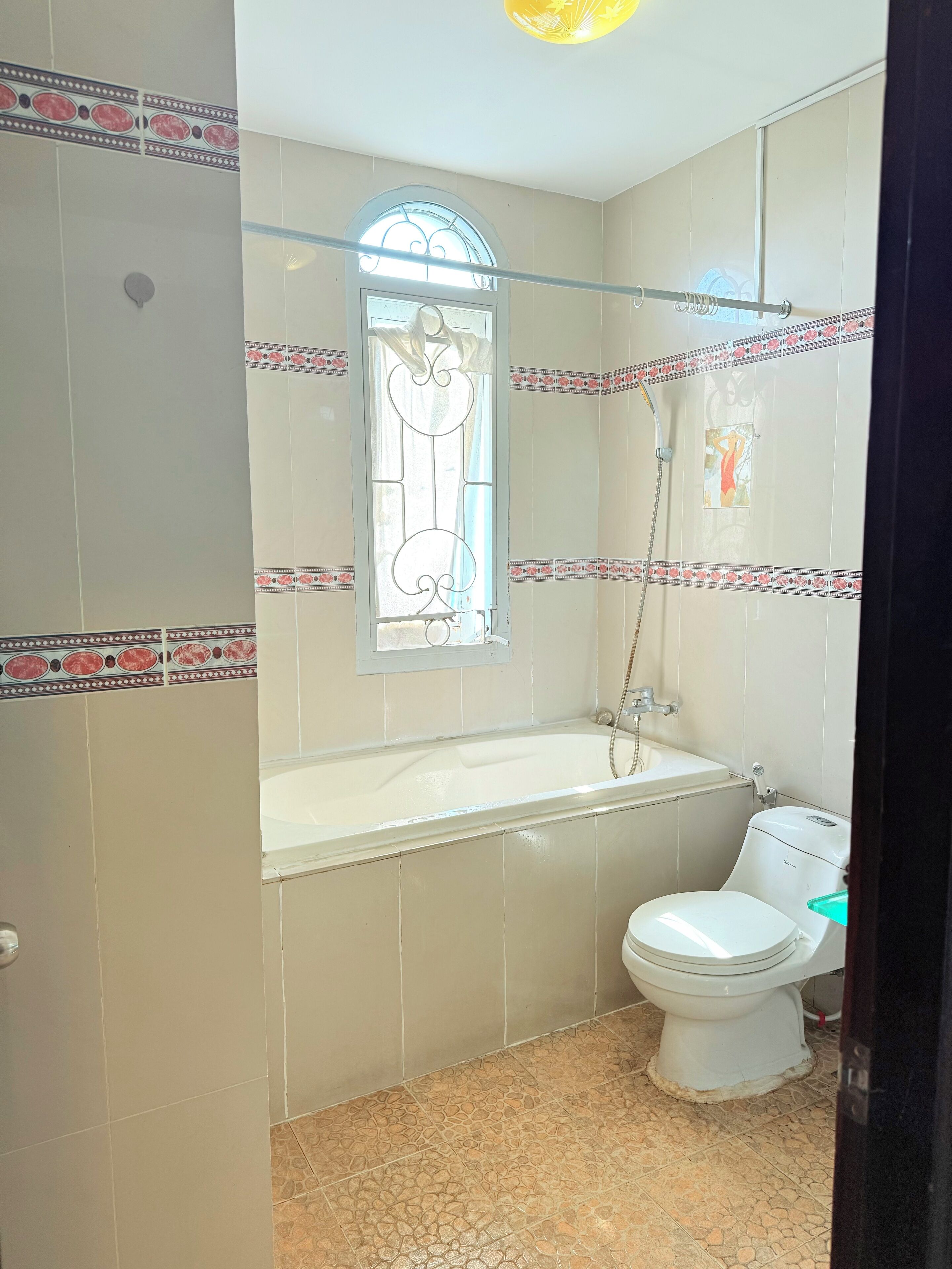 A bathroom with a bathtub, toilet, and a shower.