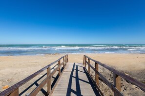 Walk along the boardwalk to the sandy beach.