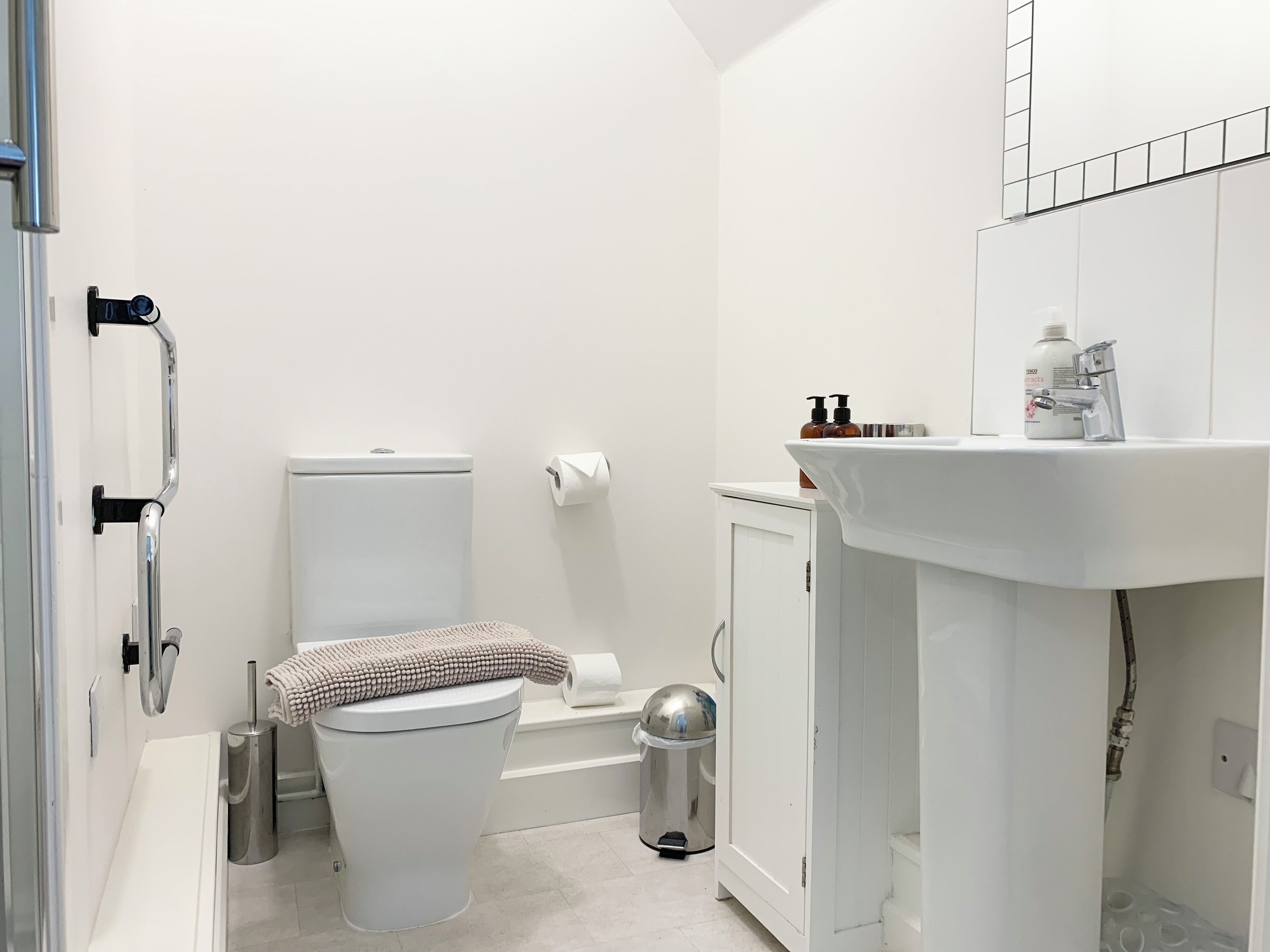 A small, modern bathroom with a toilet, bidet, and sink.