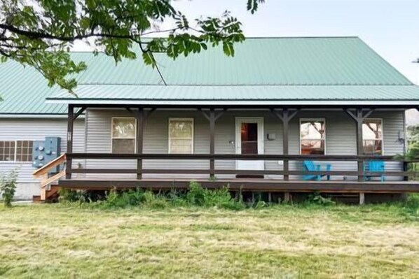 A single-story house with a porch, a green roof, and a small front yard. - Country Lake House in Alpine Wyoming (Alpine Northwest)