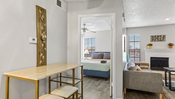 A modern living room with a sofa, a coffee table, and a fireplace. - PERFECT FOR LONG STAYS! CENTRAL DFW (Dallas)