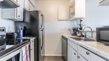 Fridge, microwave, coffee/tea maker, cookware/dishes/utensils