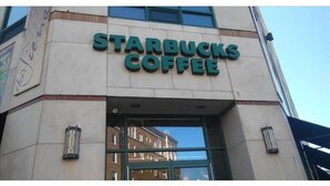 The exterior of a Starbucks Coffee building with a clear glass entrance and a visible street number 40. - Chic, Spacious Pet Friendly Apt Near Attractions/Food/EWR/NYC (West Orange)