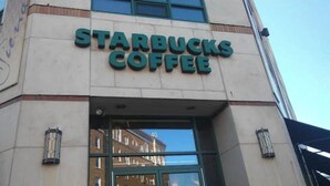 The exterior of a Starbucks Coffee building with a clear glass entrance and a visible street number 40.