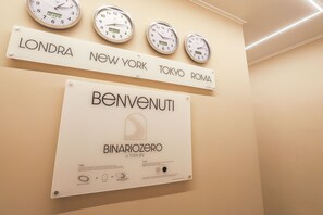 A wall with clocks and signs indicating different cities. - Binaro 0 a Termini (Rome)