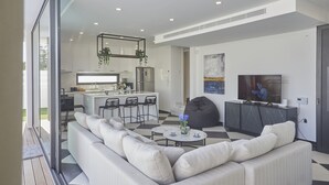 Una sala de estar moderna con un sofá, una mesa de centro y un televisor.