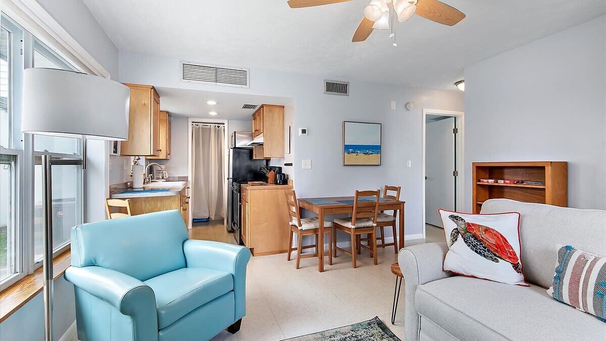A compact living space with a kitchenette, dining area, and seating.