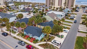 A coastal residential area with a mix of single-family homes and a large hotel.