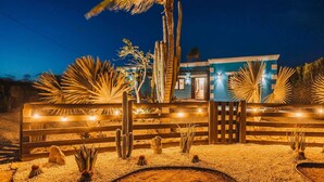 A desert-style building with a wooden fence, cacti, and palm trees. - Villa Rancho Azul Mins to Palm Beach & Eagle Beach (Noord)