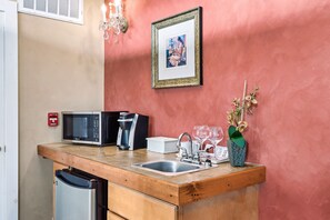 A compact kitchen with a microwave, coffee maker, sink, and a small refrigerator. - Bordeaux - Mountain View Suite with Whirlpool Tub & Fireplace (Townsend)