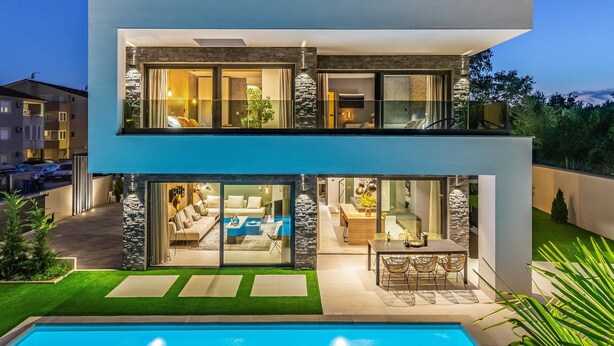 A modern two-story house with a swimming pool, glass doors, and stone accents. - Luxury Villa Xquisite with Pool (Medulin)