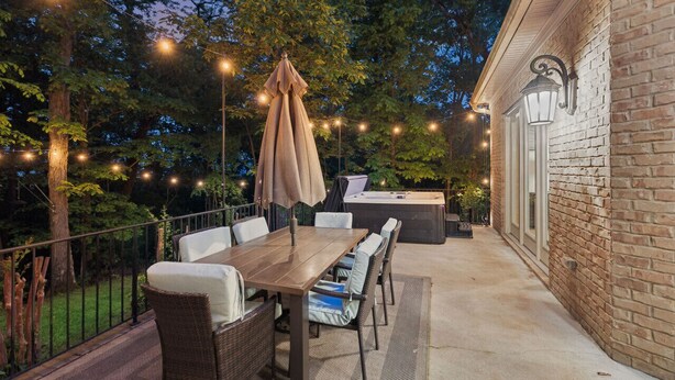 An outdoor patio with a wooden table, wicker chairs, and a barbecue grill. - Mountain Hideaway 8 acres - 5 Bedrooms + Hot Tub (Hendersonville)