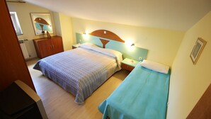 A bedroom with two beds, a wooden wardrobe, and a nightstand with a lamp. - Nova- two bedroom apartment with terrace (Zadar)
