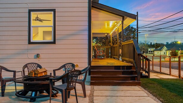 A house with a porch, outdoor seating, and a staircase leading to a covered area. - Hickory House - Family/Group and Pet-Friendly Retreat Near Lockhart Square! (Lockhart)