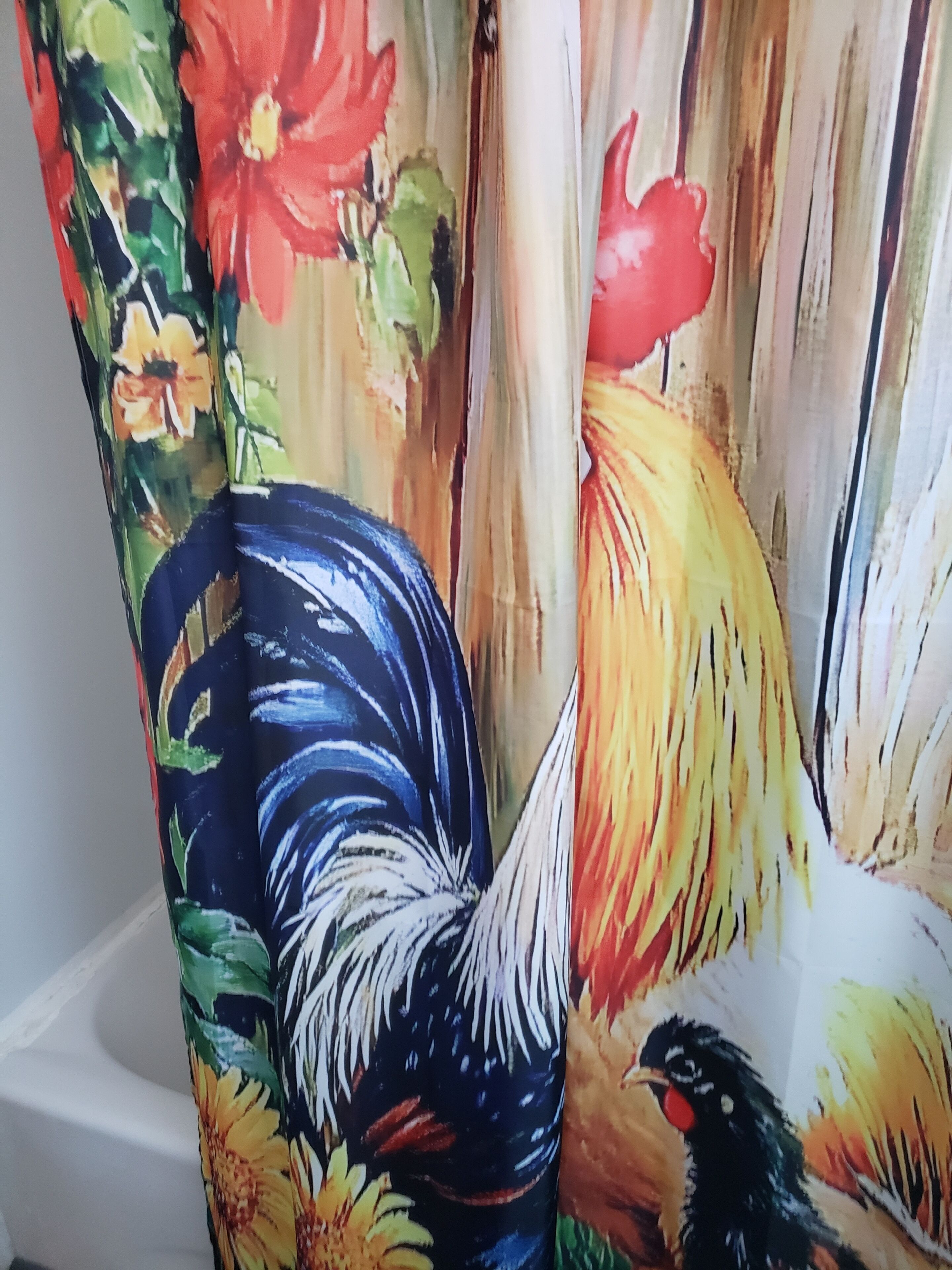A bathroom with a shower curtain featuring a rooster design.